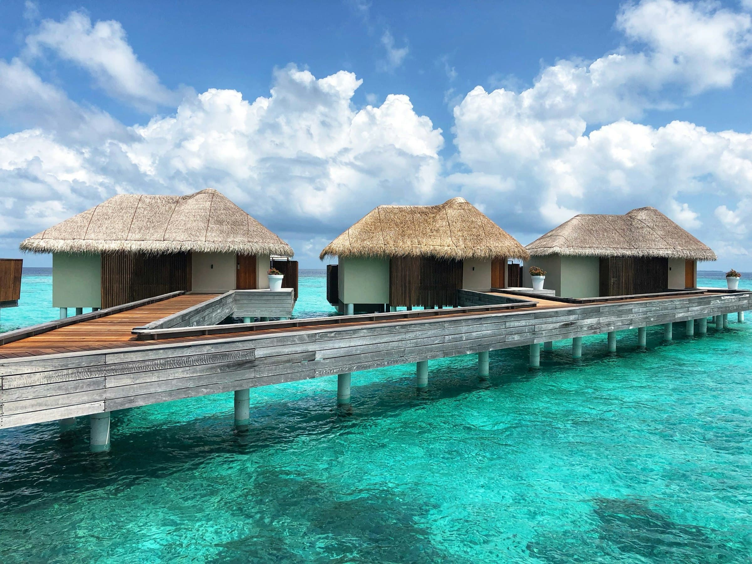 Water villas at low light, the kind of guest moment the menu has to land for.